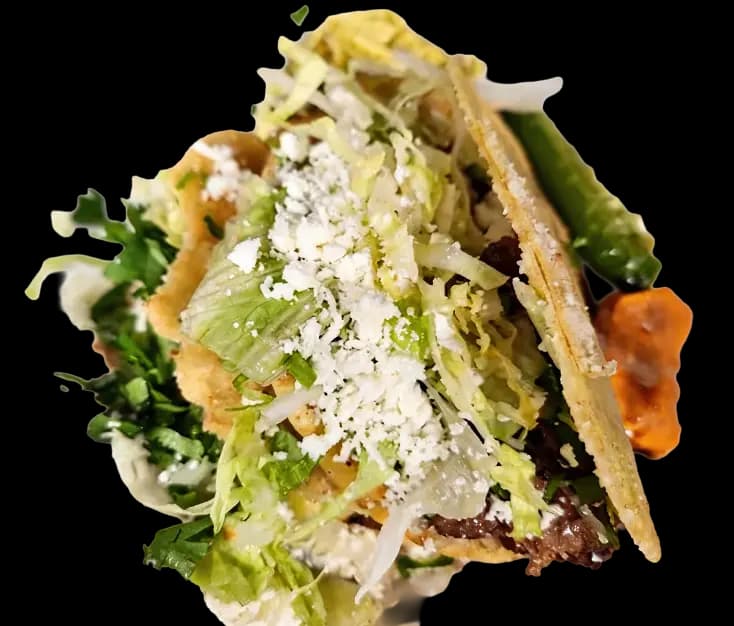 Gorditas Encantadoras stuffed with beans, lettuce, queso, sour cream, and salsa